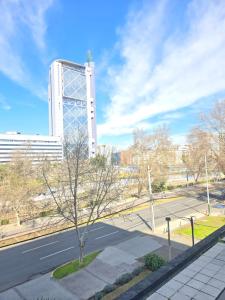 a view of a street with a building in the background at Providencia Encantador y elegante departamento in Santiago +5 photos