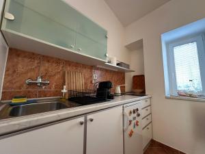 a kitchen with a sink and a window at Stari Bar Apartments in Stari Bar
