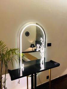 a table in a room with a mirror at Home away from your home in Islamabad