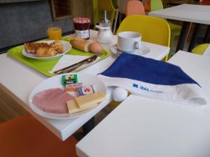 a table with a plate of food on top of it at Ibis Budget Limoges Nord in Limoges