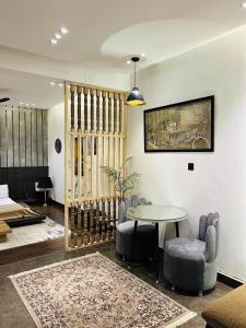 a living room with a table and chairs at Home away from your home in Islamabad