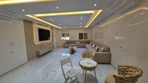 a large living room with a couch and a tv at Tanger Luxury 4BR with AC WiFi and Beach Access in Tangier