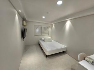 a white room with a bed and a window at Han River KS Stay in Seoul