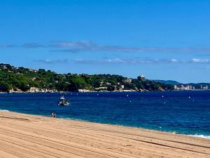 a beach with a boat in the water at Castell de Tati in Platja  d'Aro
