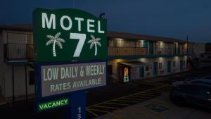 a motel sign in front of a parking lot at Motel 7 By OYO Near Phoenix Airport in Mesa