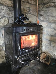an old wood stove with a fire in it at Aghavannagh Mountain Lodge in Aghavannagh