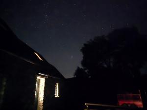 a night view of a house with the stars in the sky at Aghavannagh Mountain Lodge in Aghavannagh