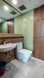 a bathroom with a toilet and a sink at Sky Suites KLCC Luxury Homestay in Kuala Lumpur