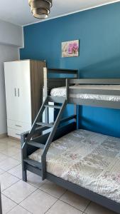 two bunk beds in a room with a blue wall at Apartment QUINTA DE AREIAS in Crespos +42 photos