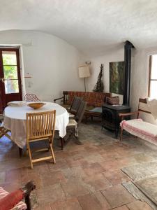 a living room with a table and a couch at Un Mazet en famille dans le jardin in Saint-Hippolyte-du-Fort