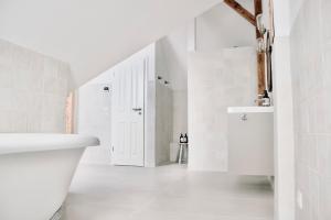 a white bathroom with a sink and a toilet at Lillebror Skandinavische Ruhe mit privater Sauna in Baden-Baden