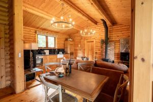 a living room with a couch and a table at Alborada in Constable Burton