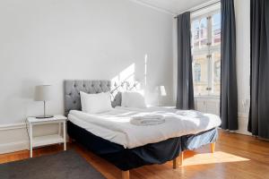a bedroom with a large bed and a window at Stay Inn Apartments in Vasastan in Stockholm
