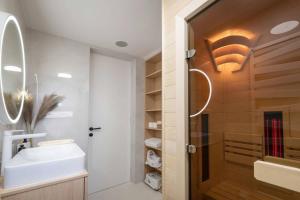 a bathroom with a sink and a shower at TRITA SK - Lebenski A27 - Infrasauna - Brand new - Parking in Vysoké Tatry