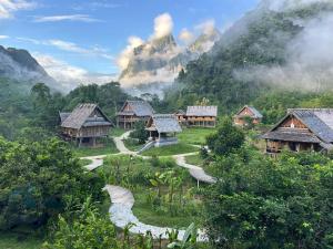 a village in the mountains with mountains in the background at Sook Village in Nongkhiaw