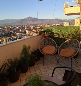 two chairs on a balcony with a view of a city at B&B Apartment in Shkodër +14 photos