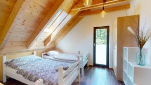 a bedroom with two beds in a attic at Dům v srdci Beskyd - Morávka - 6 pokojů in Morávka