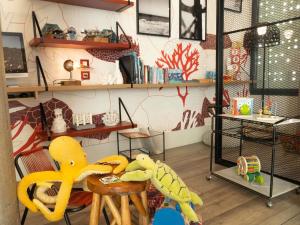 a room with a chair and a table with toys at ibis Styles Barcelona City Bogatell in Barcelona +99 photos