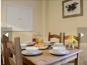 a table with plates and bowls on top of it at Burwarton cottage in Burwarton
