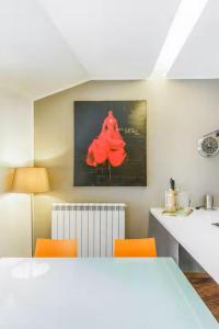 a kitchen with a white table and orange chairs at Villetta Ginori - Private Spa in Grosseto