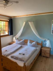 a bedroom with two twin beds with mosquito nets at Urbanshof Herr Tobias Fehrenbach in Hinterzarten
