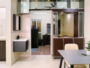 a kitchen with a table and a dining room at Batu Caves Cozy 2 Storey House with Free Netflix in Batu Caves
