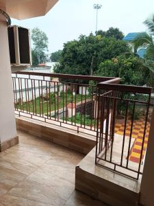 a balcony with a view of a garden at VIP Residency Hotel And Restaurant in Shānti Niketan