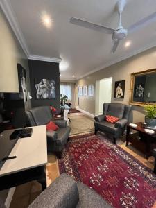 a living room with couches and a red rug at Somerset West Garden Apartments 4 in Somerset West