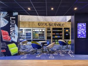 a room with a table and chairs in a store at ibis budget Amsterdam City South in Amstelveen
