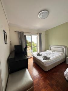 a hotel room with two beds and a balcony at VILLA Valhalla Private heated swimming-pool in Funchal +66 photos