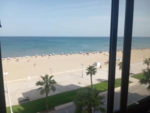 a view of a beach from a hotel window at Casa de Marinero in Martil