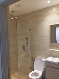 a bathroom with a shower with a toilet and a sink at Casa de Marinero in Martil