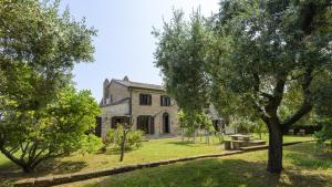 an old stone house with trees in front of it at Ca Lucciola 12 by Marche Holiday Villas in Montemaggiore al Metauro