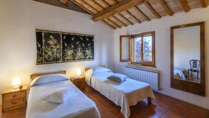a bedroom with two beds and a window at Ca Lucciola 12 by Marche Holiday Villas in Montemaggiore al Metauro +47 photos