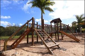 a park with a wooden playground in the sand at Casa Verão Guaratuba - Bertioga in Bertioga
