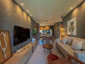 ein Wohnzimmer mit einem großen Flachbildfernseher in der Unterkunft Villa Manatee Rota dos Milagres in Tatuamunha