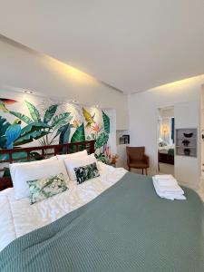 a bedroom with a large bed with a tropical mural at Hillside Condo 2 in Chiang Mai +15 photos
