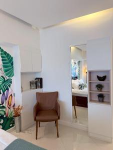 a room with a chair and a mirror and a bed at Hillside Condo 2 in Chiang Mai