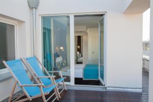 two chairs on a balcony with a bedroom at Motel One Berlin Mitte in Berlin