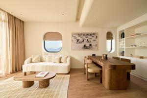 a living room with a couch and a table at Hotel Chavana Da Nang in Danang +41 photos