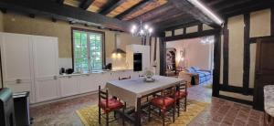 a kitchen and dining room with a table and chairs at Domaine du Cèdre Eternel in Saint-Colomb-de-Lauzun