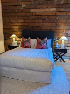 a bedroom with a large bed with pillows on it at Quentin's Cottage in Queenstown