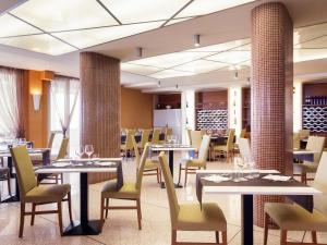 a dining room with tables and chairs and tablesktop at Ibis Styles Bari Giovinazzo in Giovinazzo