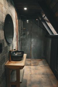 a bathroom with a sink and a shower at Highland Apartments Pod Gubałówką in Zakopane
