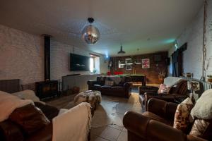 a large living room with couches and a tv at The Cottage at Barraston Farm in Balmore +42 photos