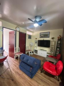 a living room with a blue couch and a tv at Jb Place Hernan in Cebu City