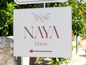 a sign that says nya home with an arrow at Naya Home - New listing! in Almirida