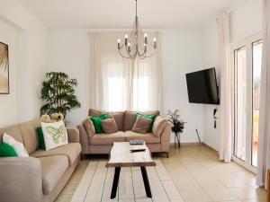 a living room with a couch and a table at Naya Home - New listing! in Almirida