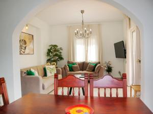 a living room with a table and a couch at Naya Home - New listing! in Almirida +41 photos