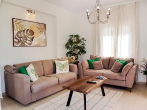 a living room with two couches and a coffee table at Naya Home - New listing! in Almirida